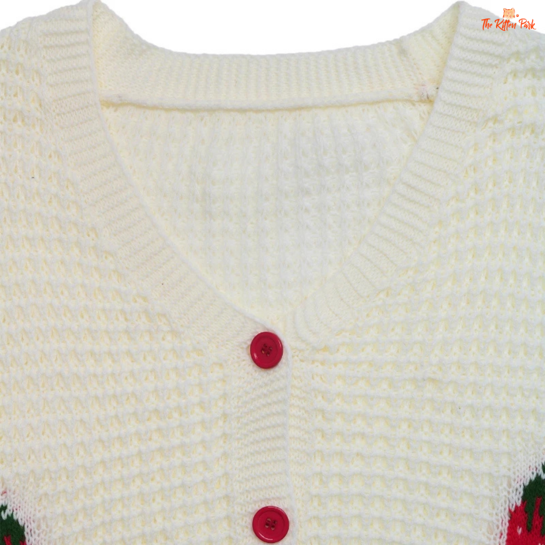 Close-up of a white knitted cardigan with red buttons on a white background
