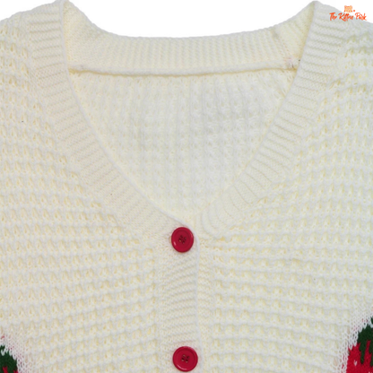 Close-up of a white knitted cardigan with red buttons on a white background