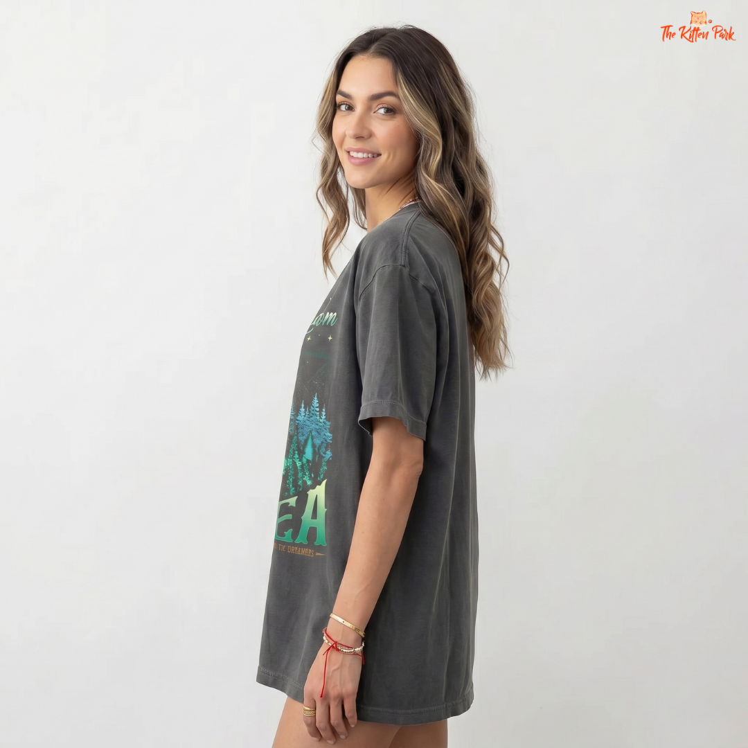 Woman wearing a dark gray t-shirt with a graphic design on a white background