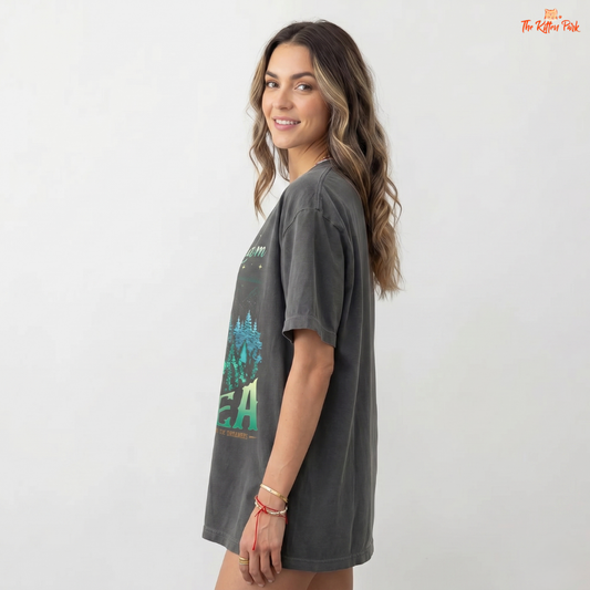 Woman wearing a dark gray t-shirt with a graphic design on a white background