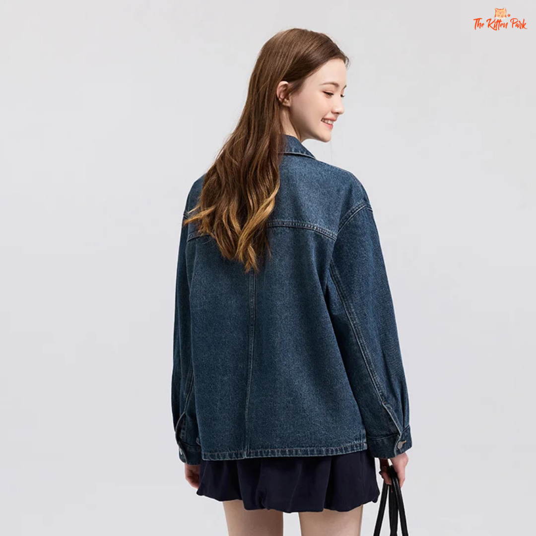 A women’s casual elegant denim jacket with a loose fit, lapel turn-down collar, drop shoulders, full sleeves, and pockets – ideal for spring wear.