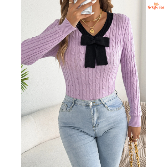 Elegant V-Neck Contrast Bow Knitted Sweater for Women in pastel pink and lilac gradient background, slim fit with bow accents and cozy knit fabric.