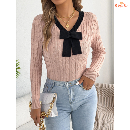 Elegant V-Neck Contrast Bow Knitted Sweater for Women in pastel pink and lilac gradient background, slim fit with bow accents and cozy knit fabric.
