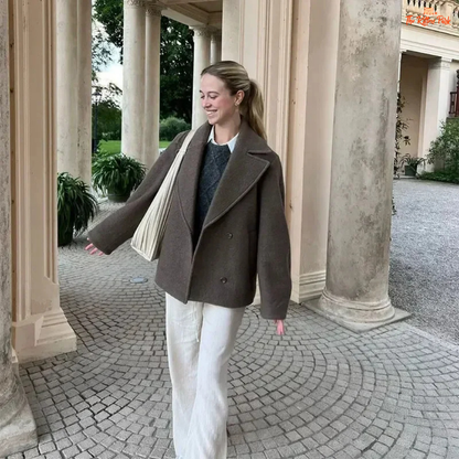 A women’s camel brown double-breasted wool coat with lapel collar, long sleeves, and a loose fit, designed for autumn and winter elegance.