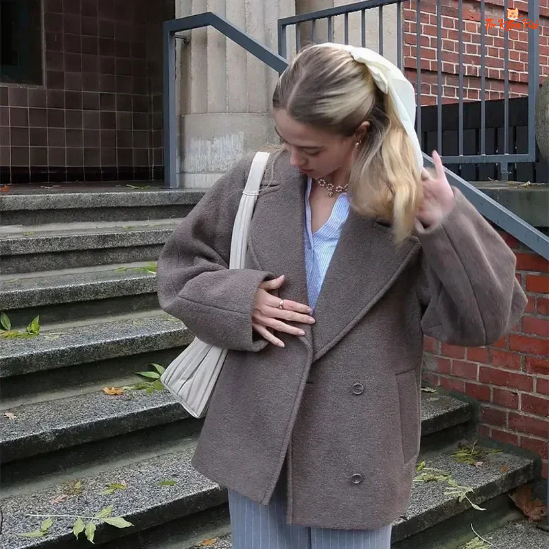A women’s camel brown double-breasted wool coat with lapel collar, long sleeves, and a loose fit, designed for autumn and winter elegance.