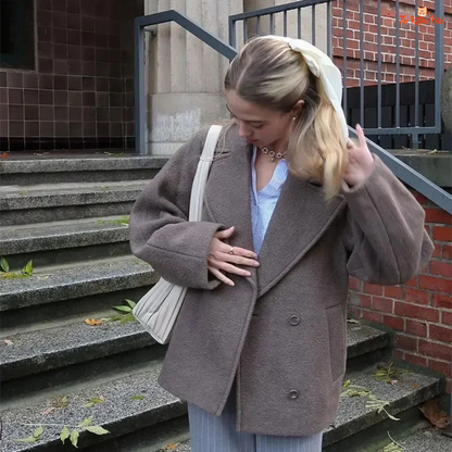 A women’s camel brown double-breasted wool coat with lapel collar, long sleeves, and a loose fit, designed for autumn and winter elegance.