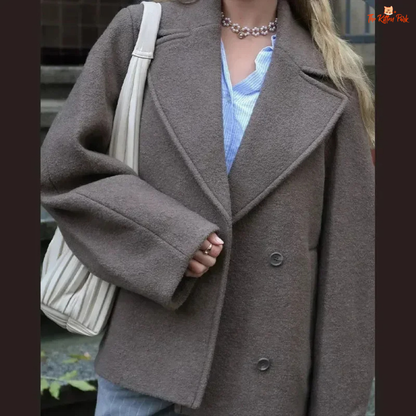 A women’s camel brown double-breasted wool coat with lapel collar, long sleeves, and a loose fit, designed for autumn and winter elegance.