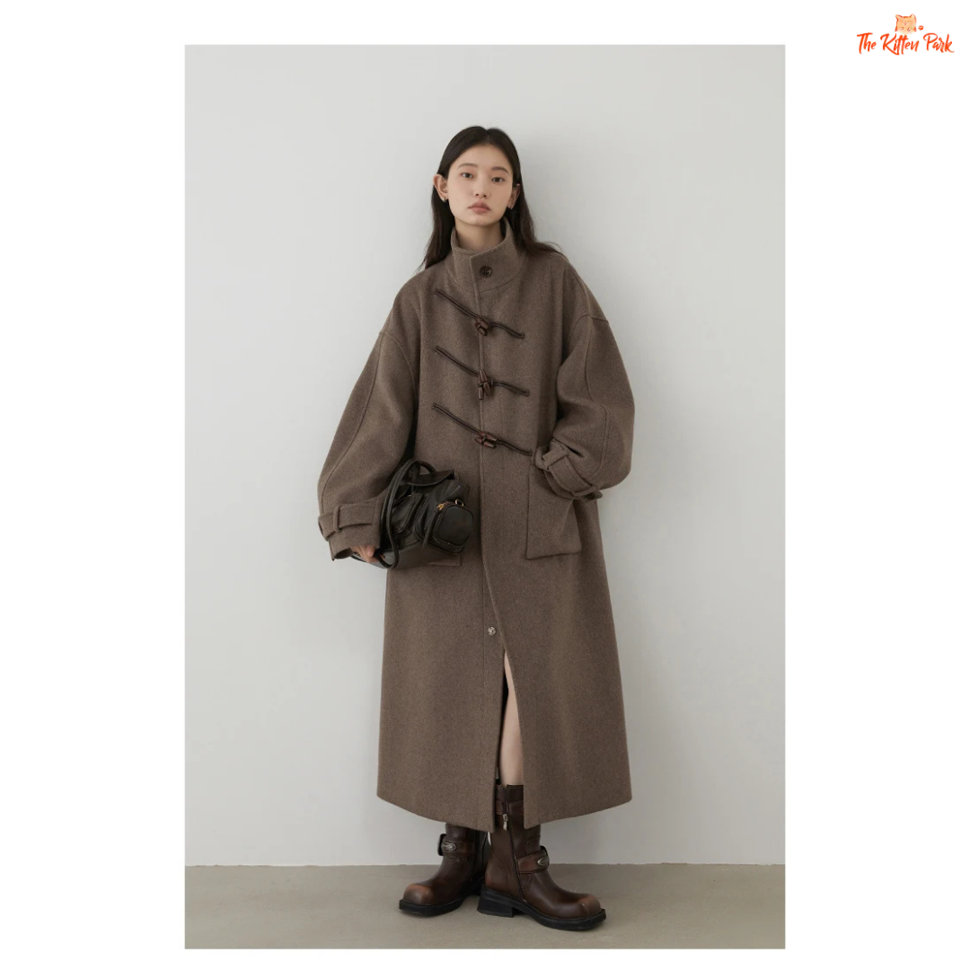 Women's long camel wool-blend overcoat with single-breasted front, stand collar, drop-shoulder sleeves, wide-waisted fit, and button details for autumn/winter.