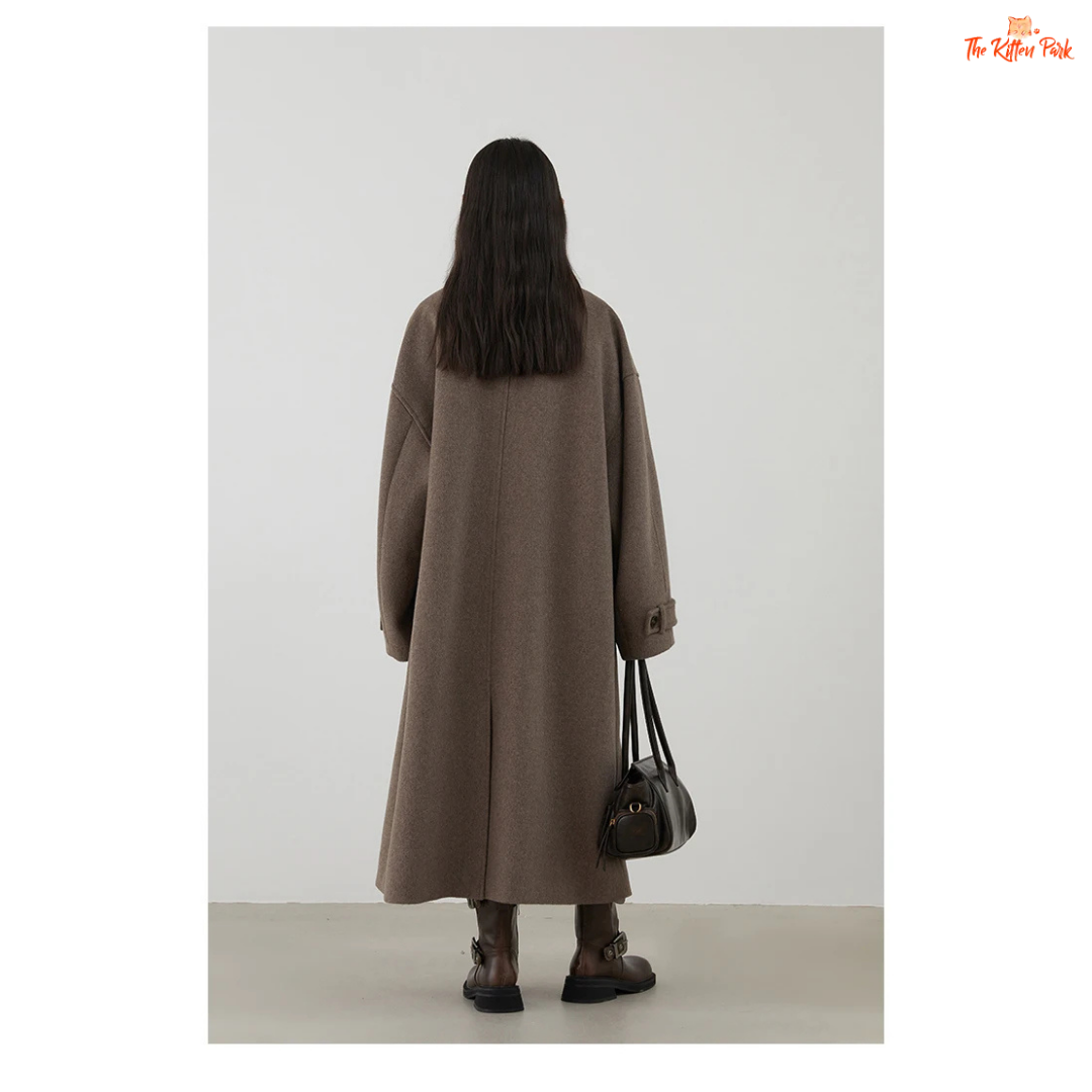 Women's long camel wool-blend overcoat with single-breasted front, stand collar, drop-shoulder sleeves, wide-waisted fit, and button details for autumn/winter.