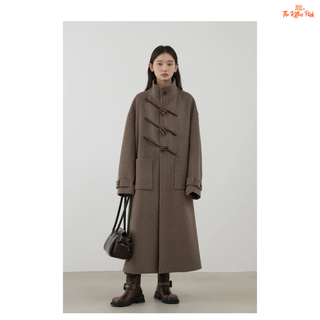 Women's long camel wool-blend overcoat with single-breasted front, stand collar, drop-shoulder sleeves, wide-waisted fit, and button details for autumn/winter.