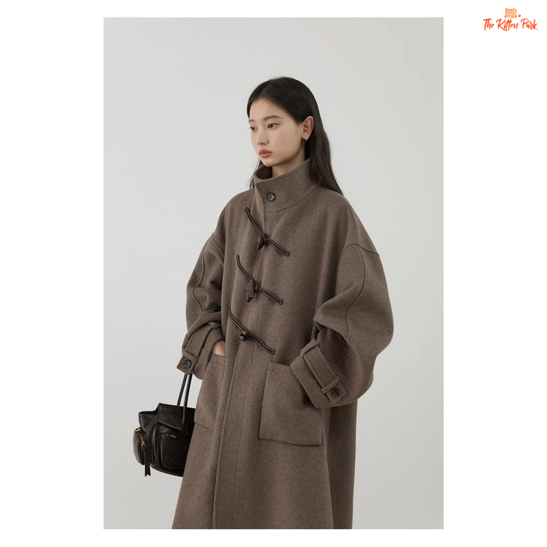 Women's long camel wool-blend overcoat with single-breasted front, stand collar, drop-shoulder sleeves, wide-waisted fit, and button details for autumn/winter.