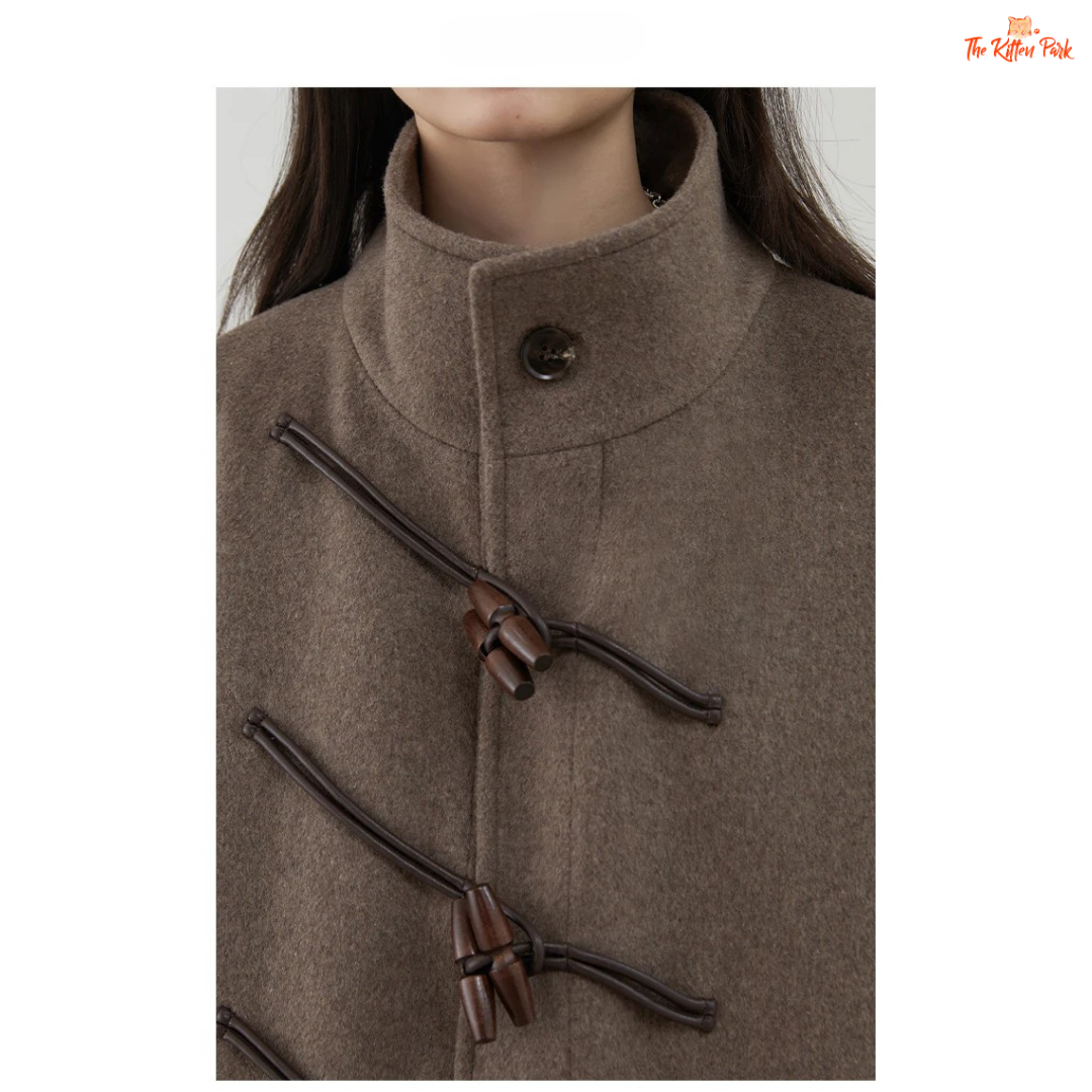 Women's long camel wool-blend overcoat with single-breasted front, stand collar, drop-shoulder sleeves, wide-waisted fit, and button details for autumn/winter.