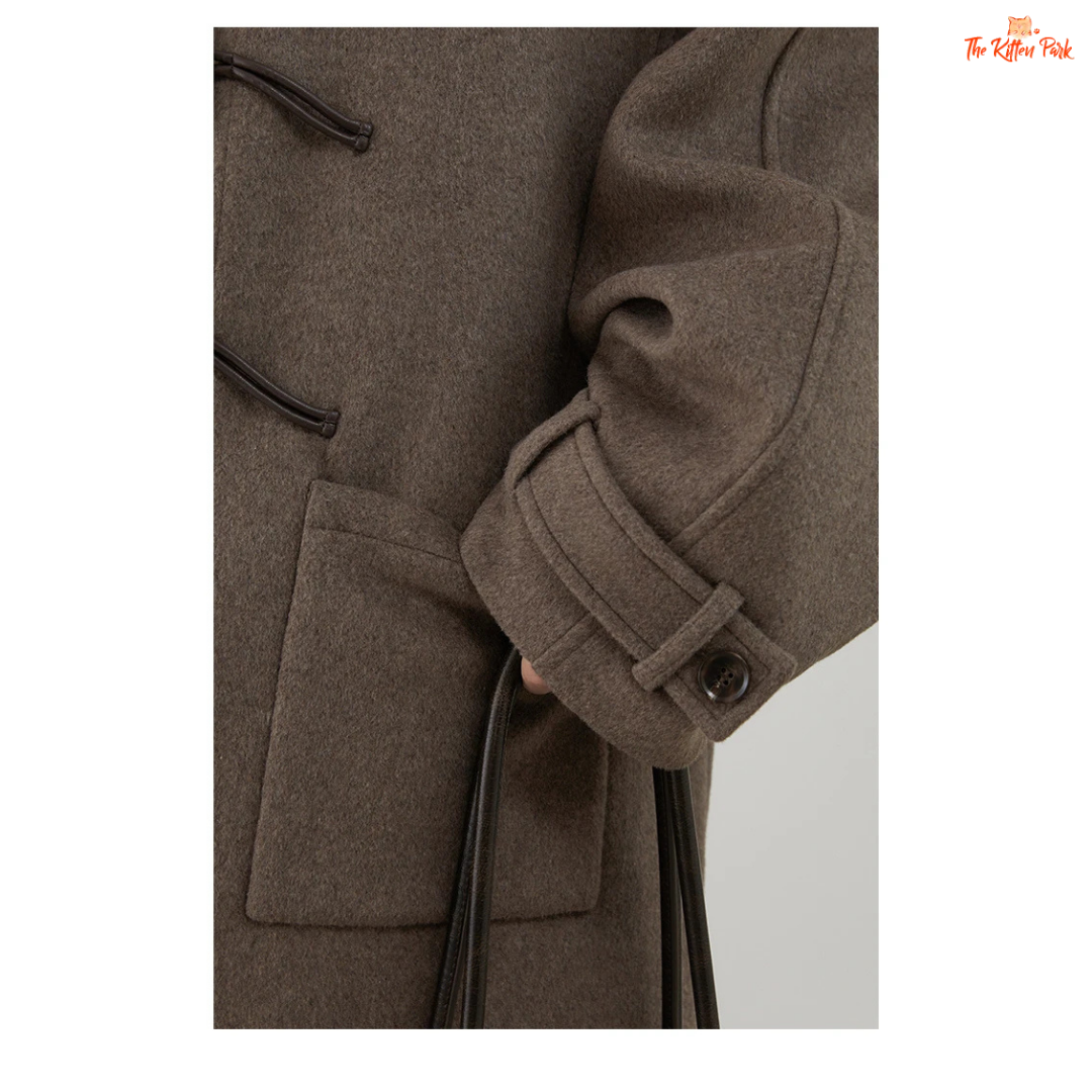 Women's long camel wool-blend overcoat with single-breasted front, stand collar, drop-shoulder sleeves, wide-waisted fit, and button details for autumn/winter.