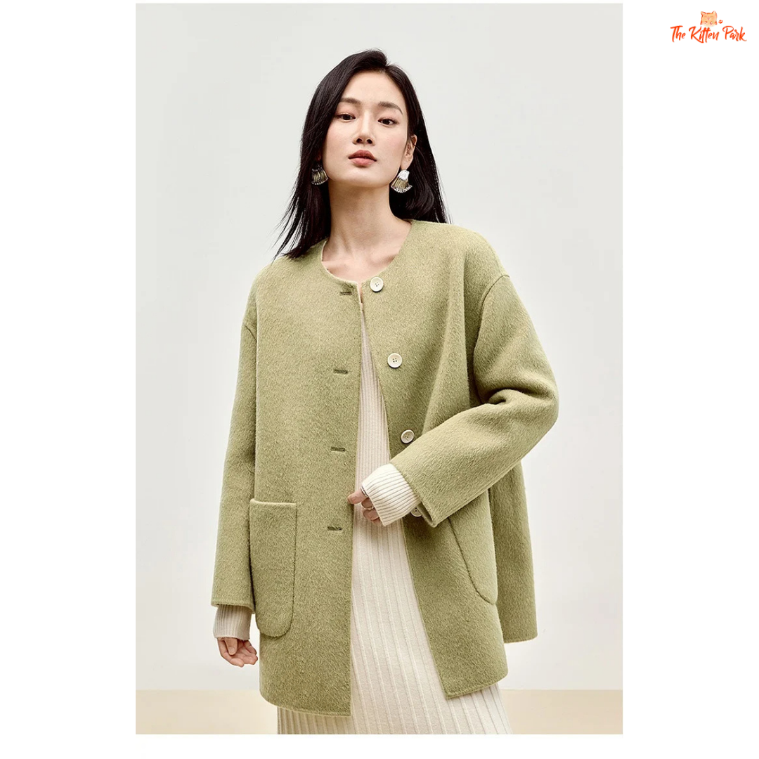 Women’s 100% wool double-sided winter coat in light pistachio and off-white tones, featuring an O-neck, single-breasted closure, pockets, and scarf detail.