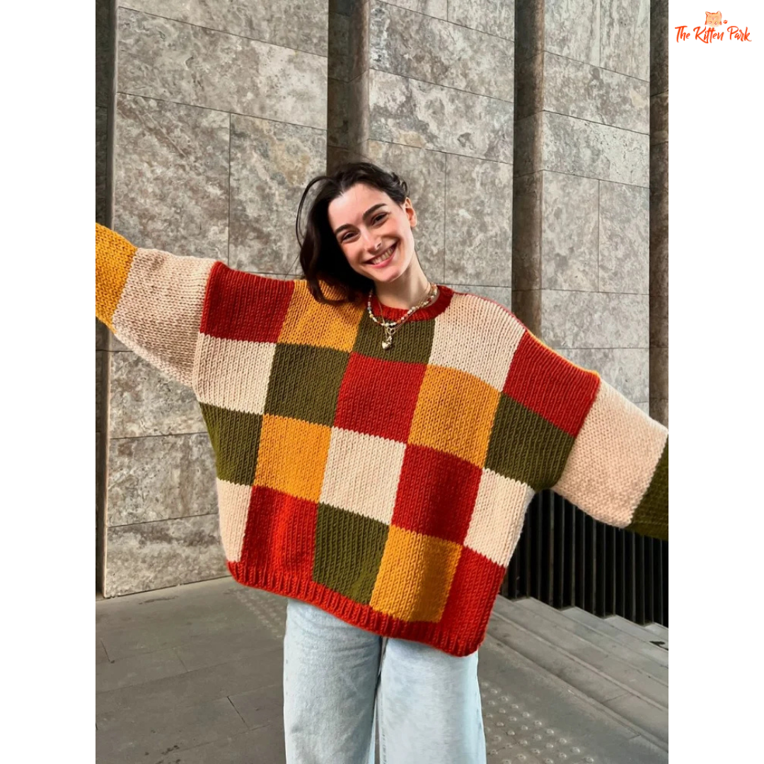 A women’s loose knit sweater with a patchwork-inspired round neck design, fine yarn fabric, and a relaxed fit, perfect for autumn casual fashion.