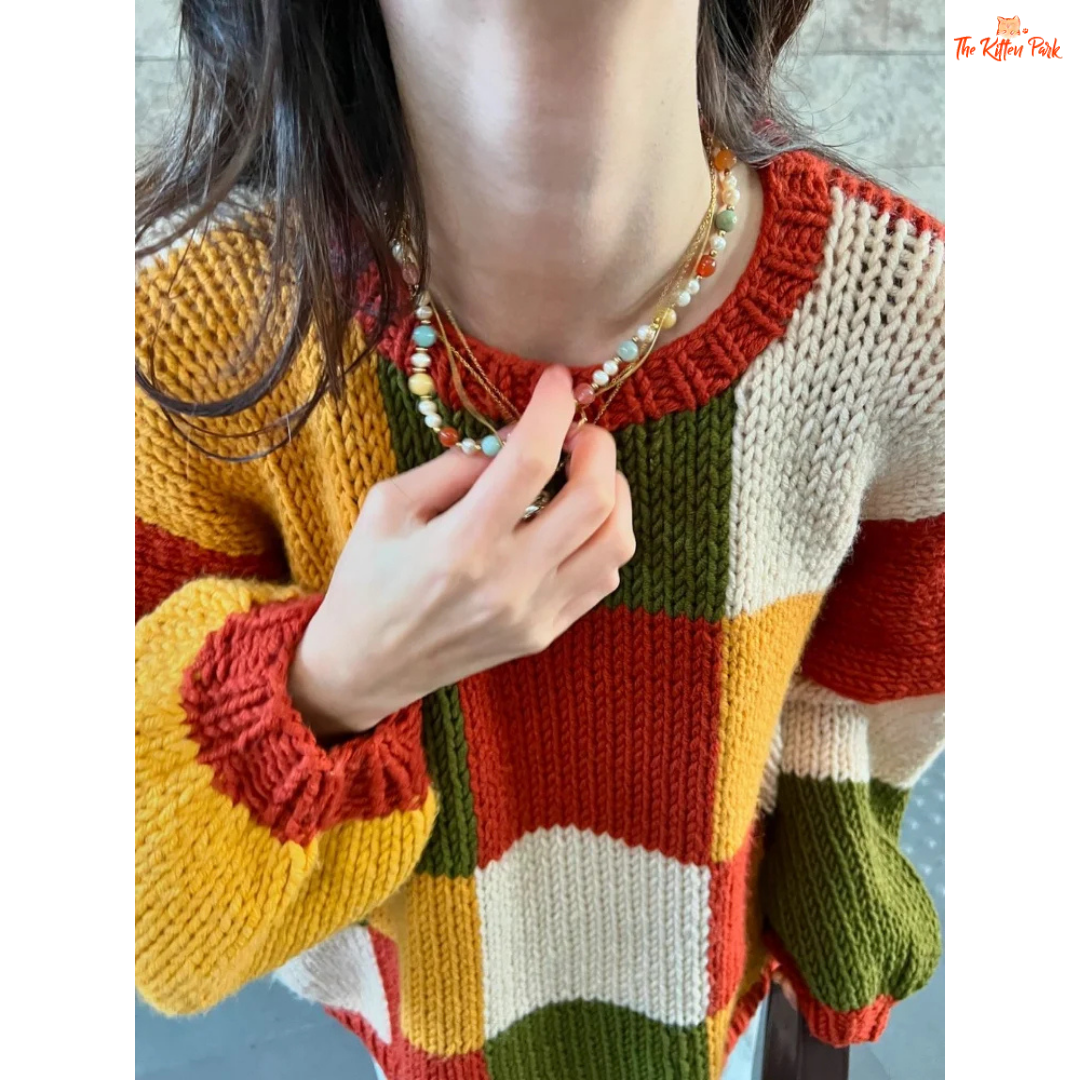 A women’s loose knit sweater with a patchwork-inspired round neck design, fine yarn fabric, and a relaxed fit, perfect for autumn casual fashion.
