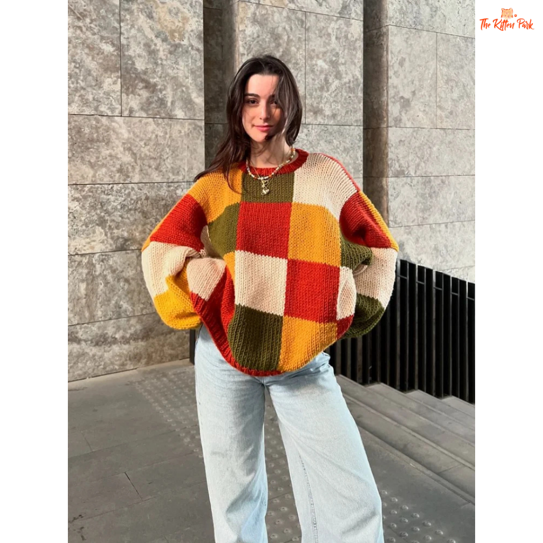 A women’s loose knit sweater with a patchwork-inspired round neck design, fine yarn fabric, and a relaxed fit, perfect for autumn casual fashion.