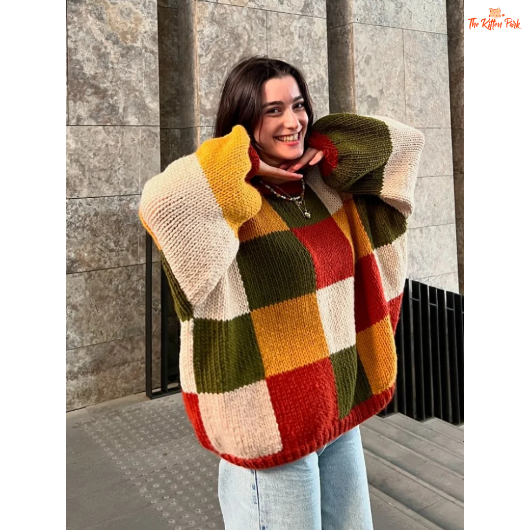 A women’s loose knit sweater with a patchwork-inspired round neck design, fine yarn fabric, and a relaxed fit, perfect for autumn casual fashion.