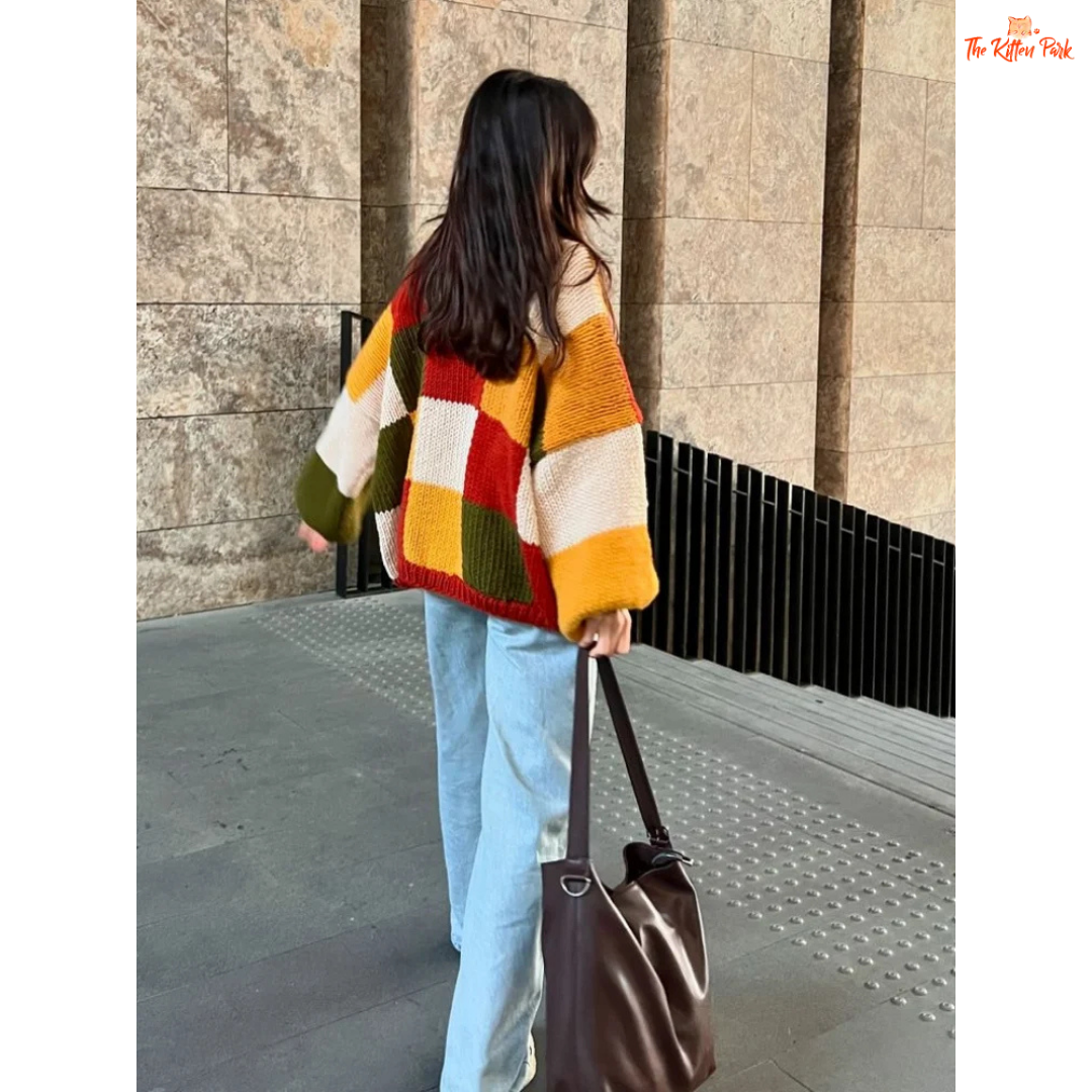 A women’s loose knit sweater with a patchwork-inspired round neck design, fine yarn fabric, and a relaxed fit, perfect for autumn casual fashion.