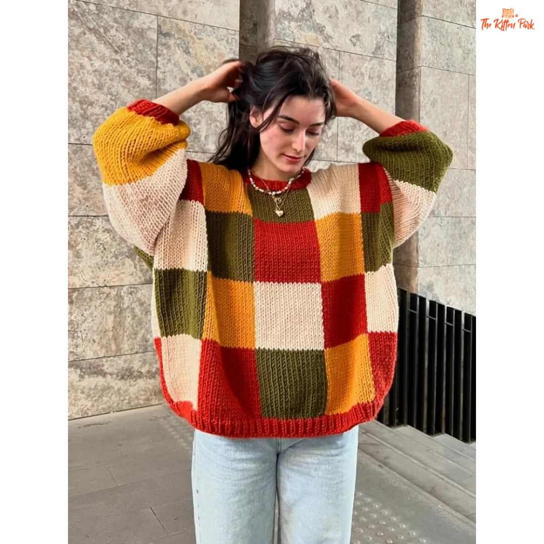 A women’s loose knit sweater with a patchwork-inspired round neck design, fine yarn fabric, and a relaxed fit, perfect for autumn casual fashion.