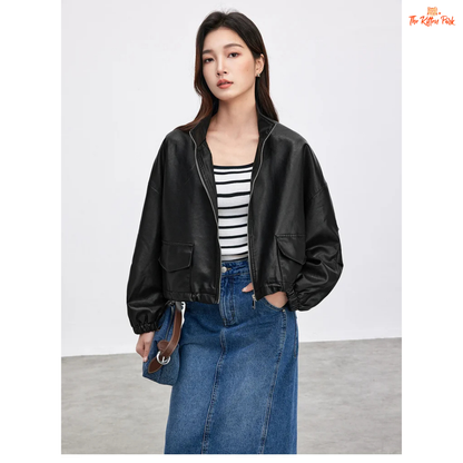 Woman wearing a black leather jacket, striped shirt, and blue jeans on a white background