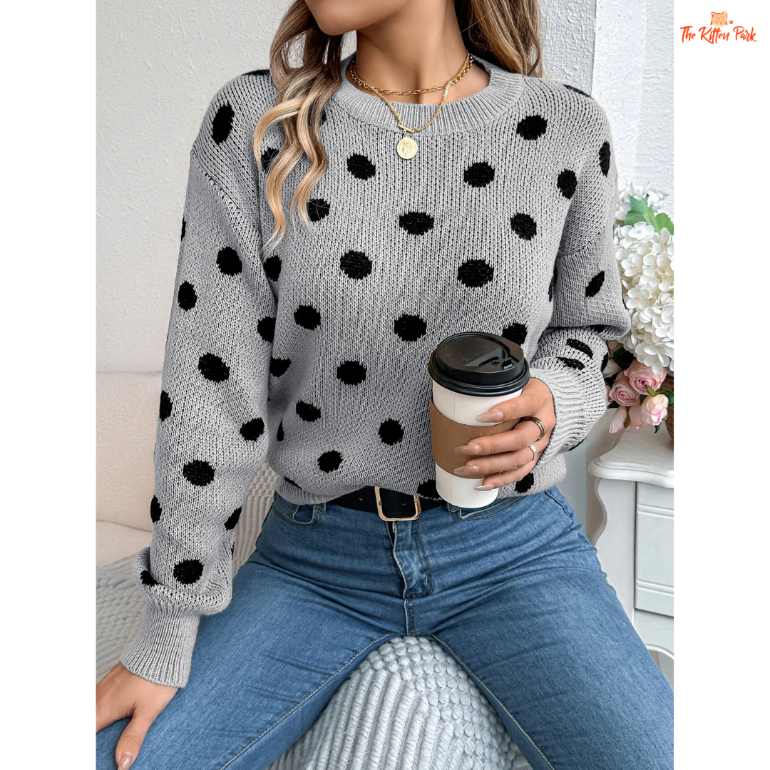 A women’s heavyweight acrylic polka dot knit sweater with lantern sleeves, O-neck, pockets, and regular fit for autumn and winter.