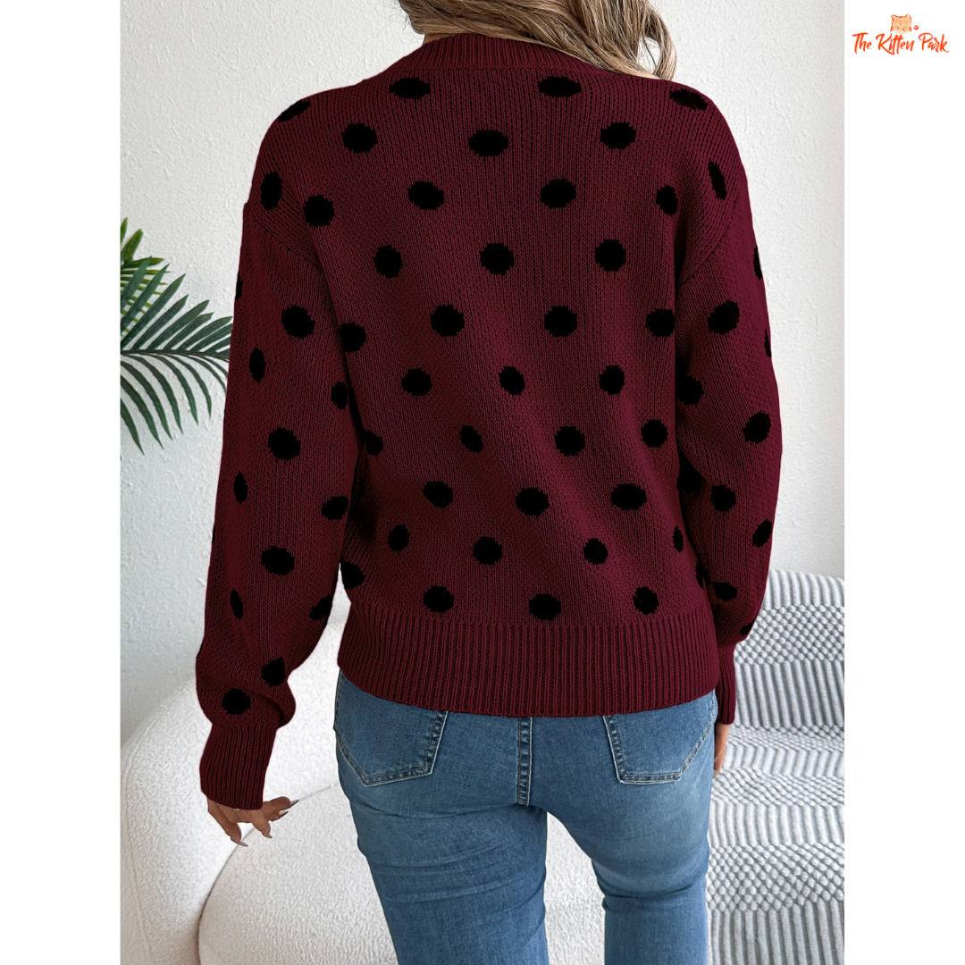 A women’s heavyweight acrylic polka dot knit sweater with lantern sleeves, O-neck, pockets, and regular fit for autumn and winter.