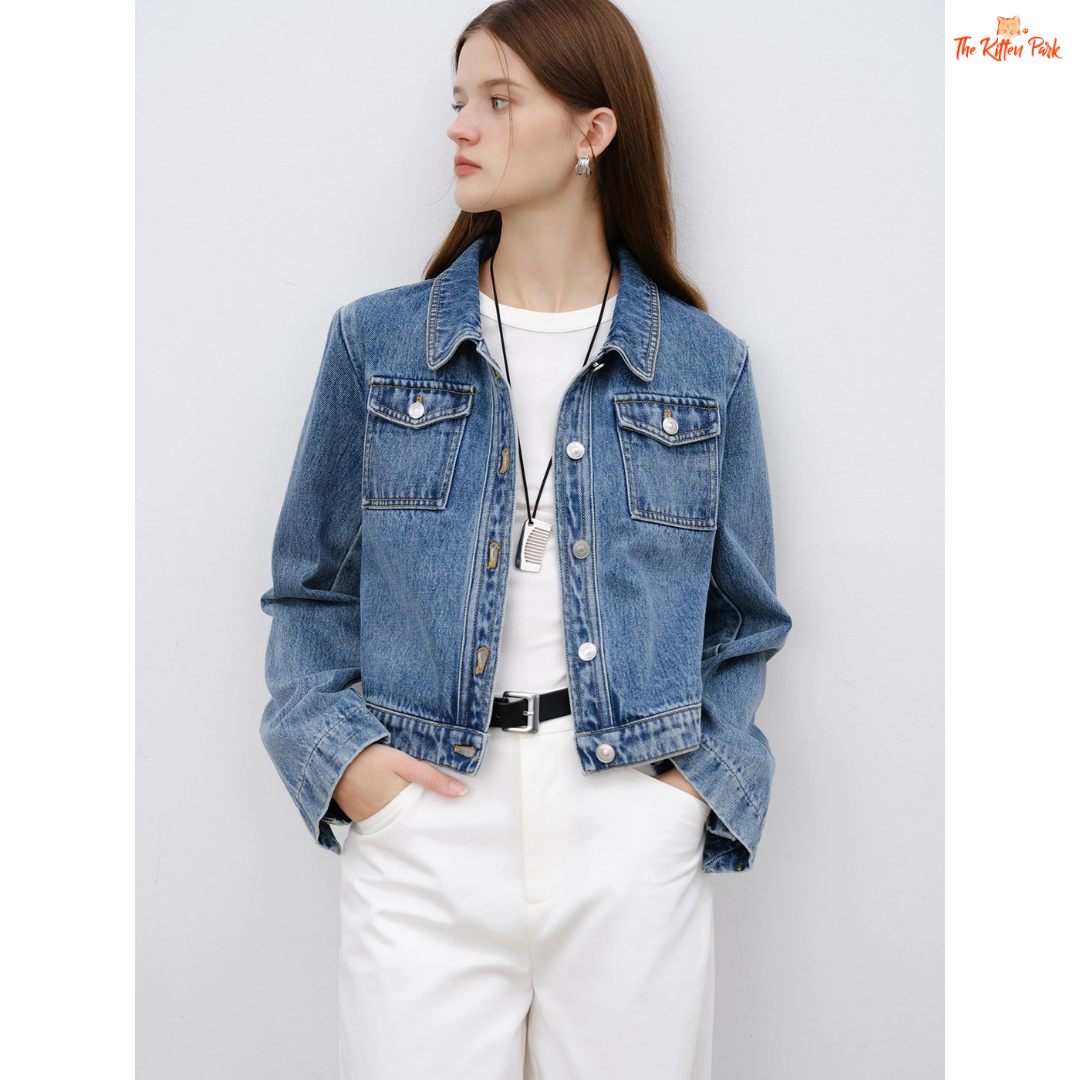 Women’s retro short denim jacket in blue cotton with turn-down collar, single-breasted closure, and buttons, styled for casual spring and summer outfits.