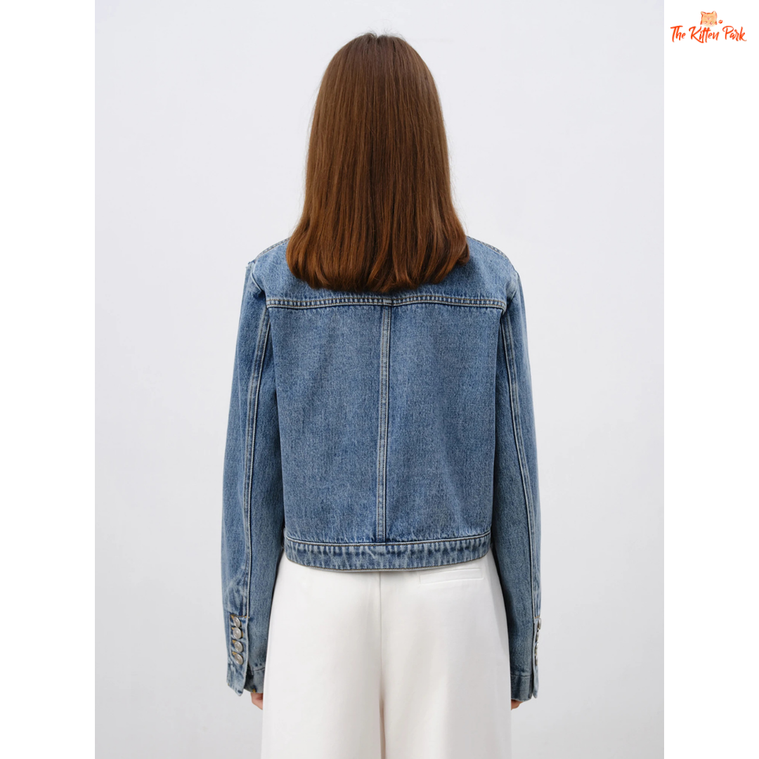 Women’s retro short denim jacket in blue cotton with turn-down collar, single-breasted closure, and buttons, styled for casual spring and summer outfits.