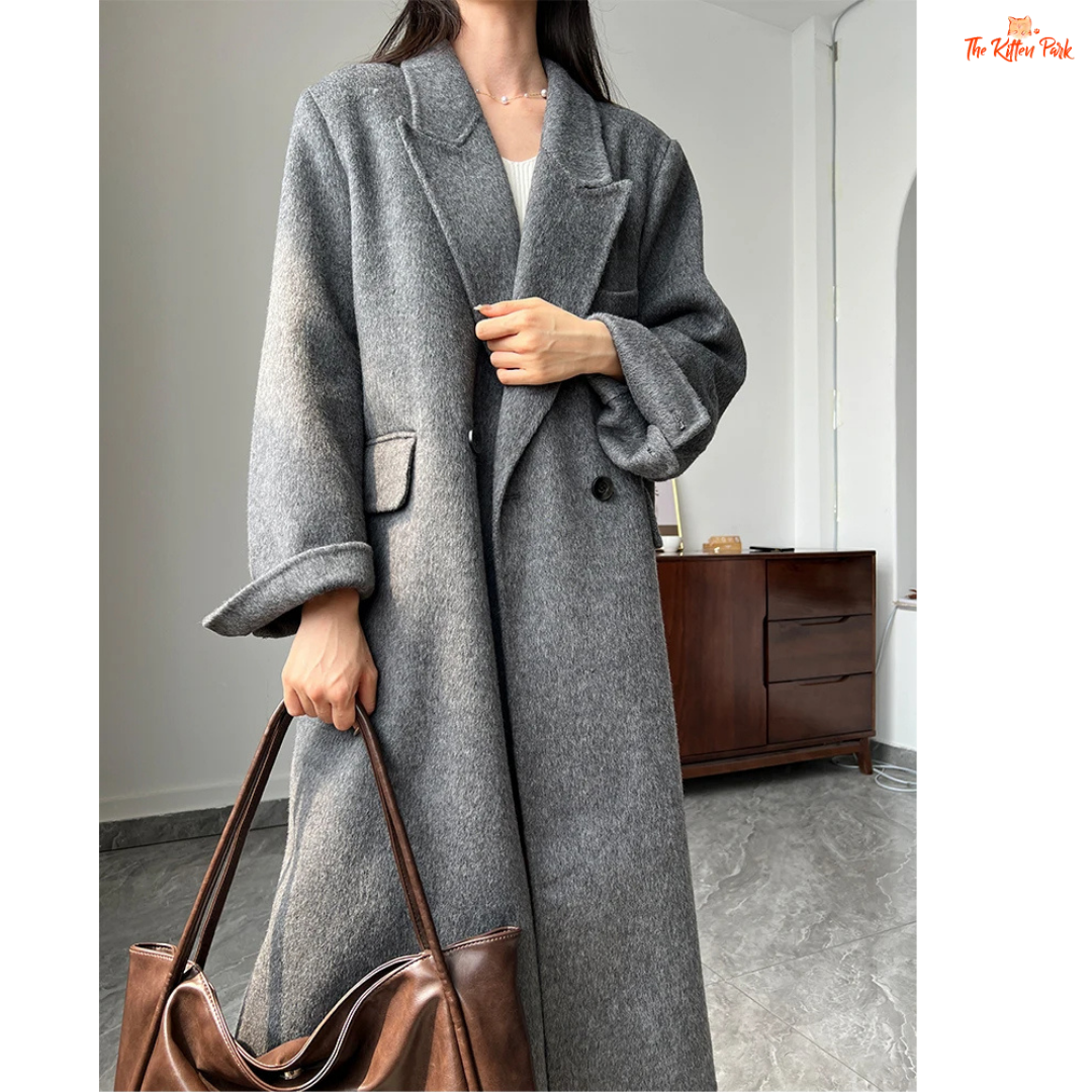 Women’s long wool coat with double-breasted closure, turn-down collar, wide-waisted fit, and button-pocket details in solid design.