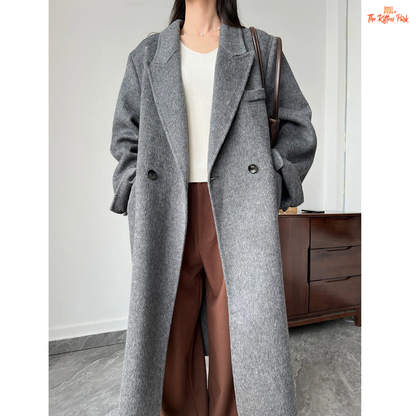 Women’s long wool coat with double-breasted closure, turn-down collar, wide-waisted fit, and button-pocket details in solid design.