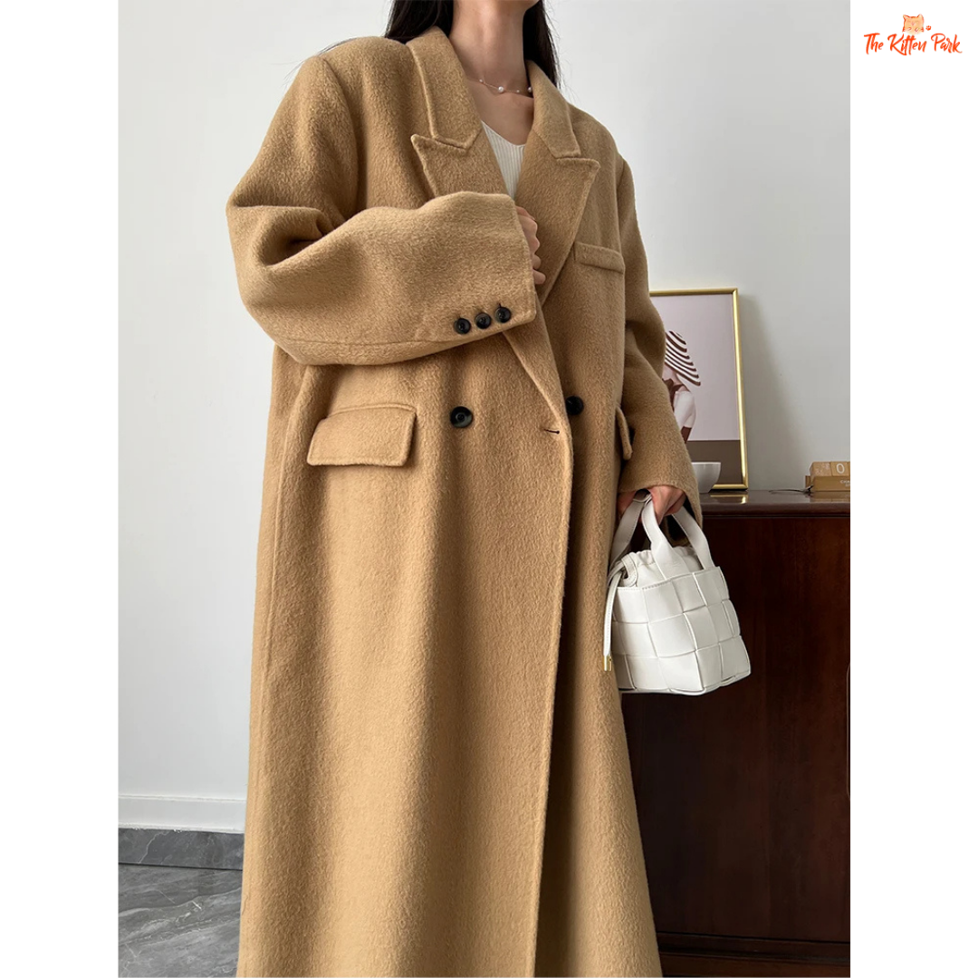 Women’s long wool coat with double-breasted closure, turn-down collar, wide-waisted fit, and button-pocket details in solid design.