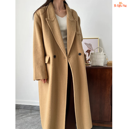 Women’s long wool coat with double-breasted closure, turn-down collar, wide-waisted fit, and button-pocket details in solid design.