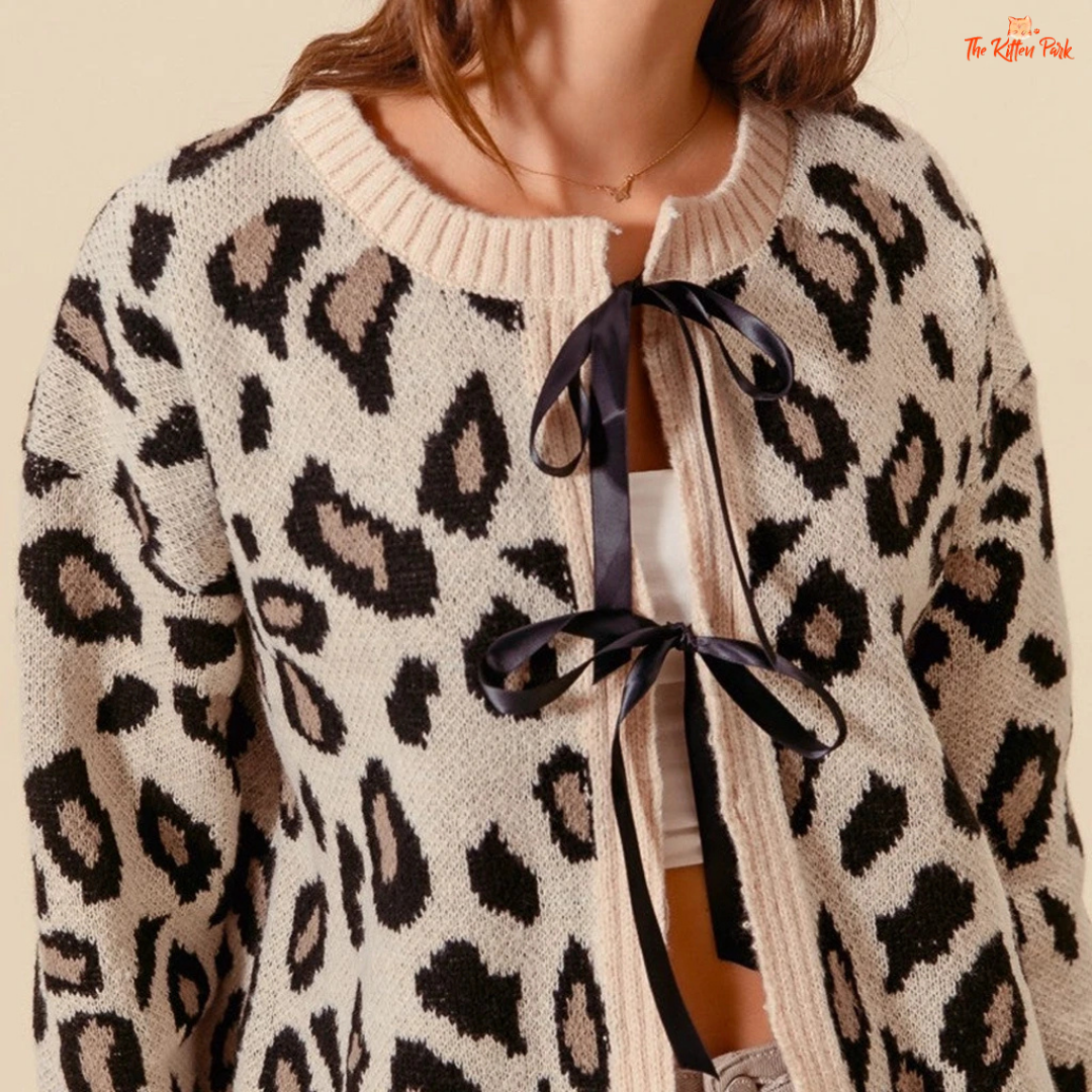 Leopard print cardigan with a ribbon detail on a neutral background