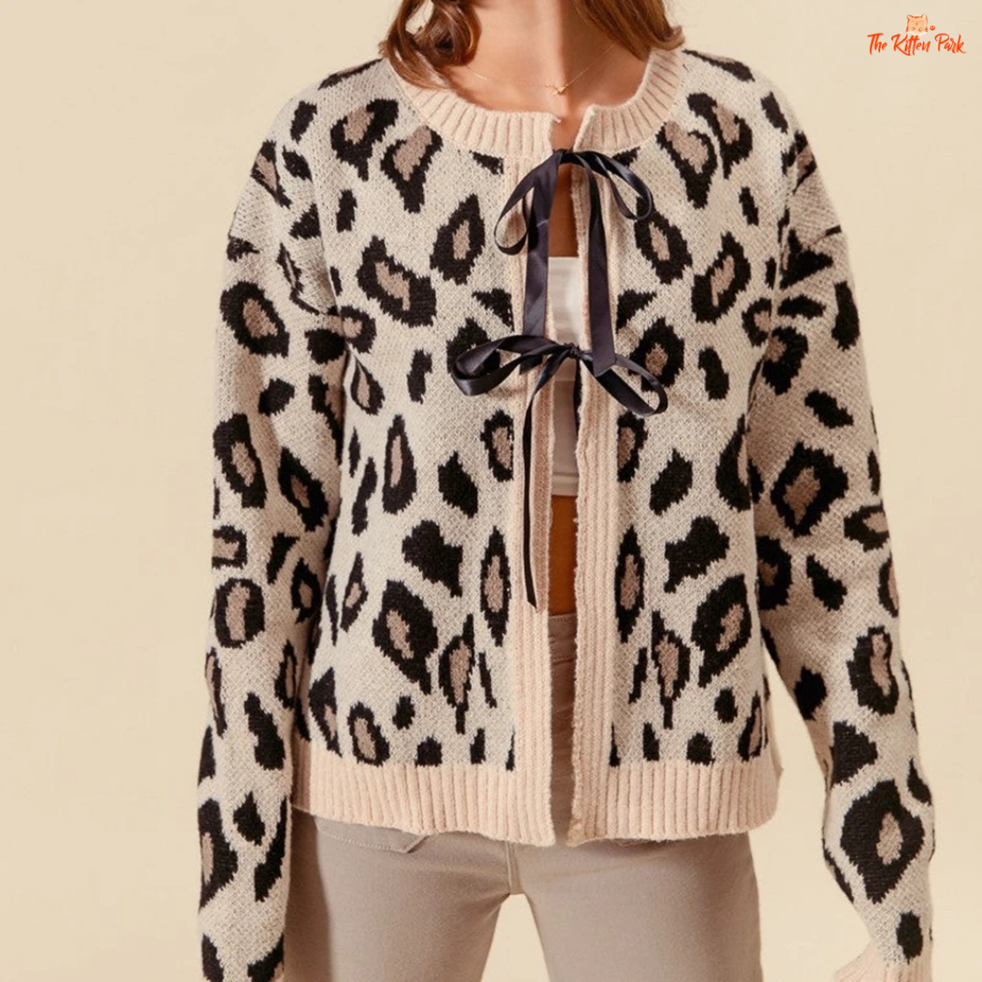 Y2K Leopard Contrast Knit Cardigan with Bow Lace-Up featuring a bold leopard pattern, short fit, and cute bow lace-up design in a soft knitted fabric.