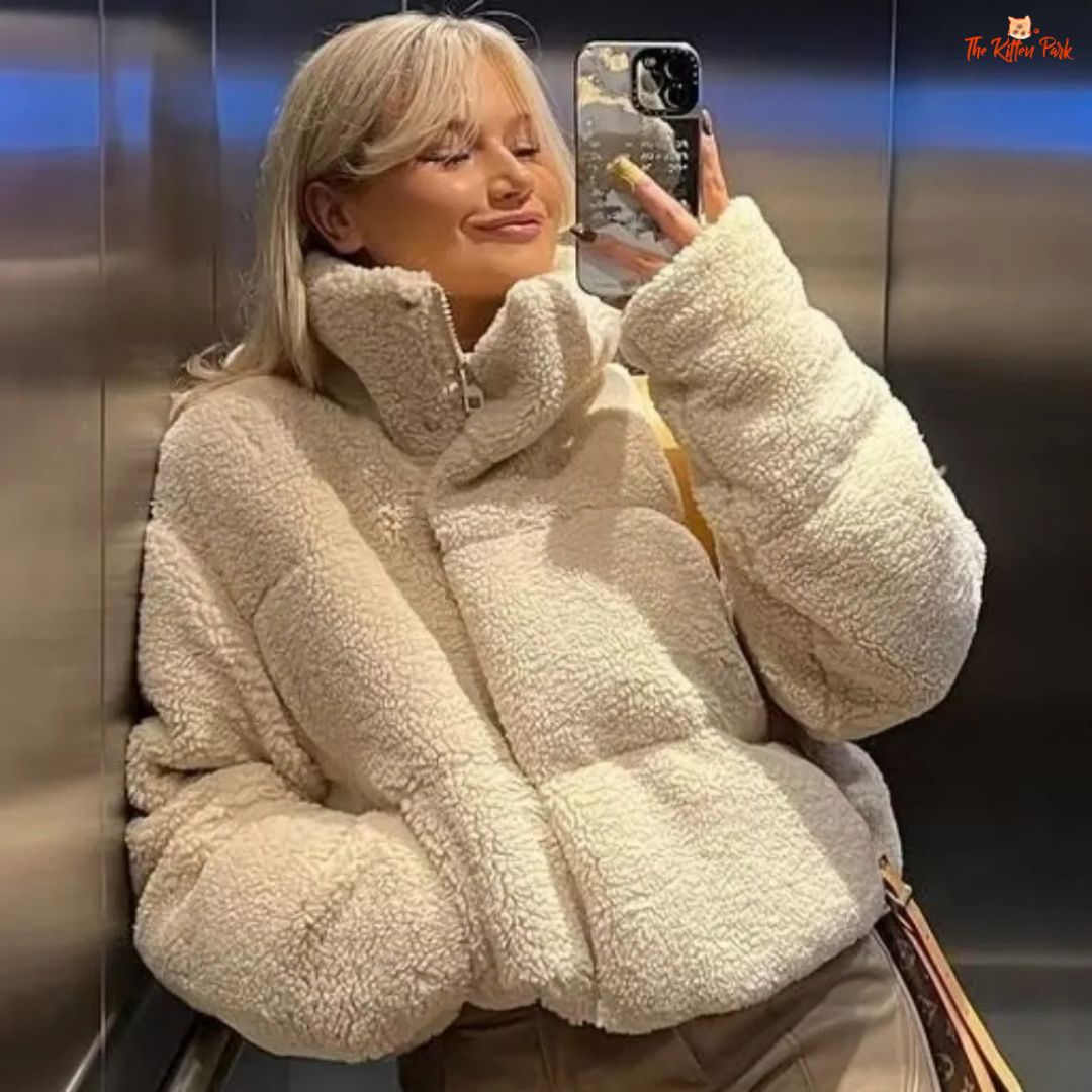 A short winter puffer coat for women with lamb wool texture, stand collar, bat sleeves, thick cotton filling, and casual zip-up style in solid color.