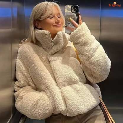 A short winter puffer coat for women with lamb wool texture, stand collar, bat sleeves, thick cotton filling, and casual zip-up style in solid color.