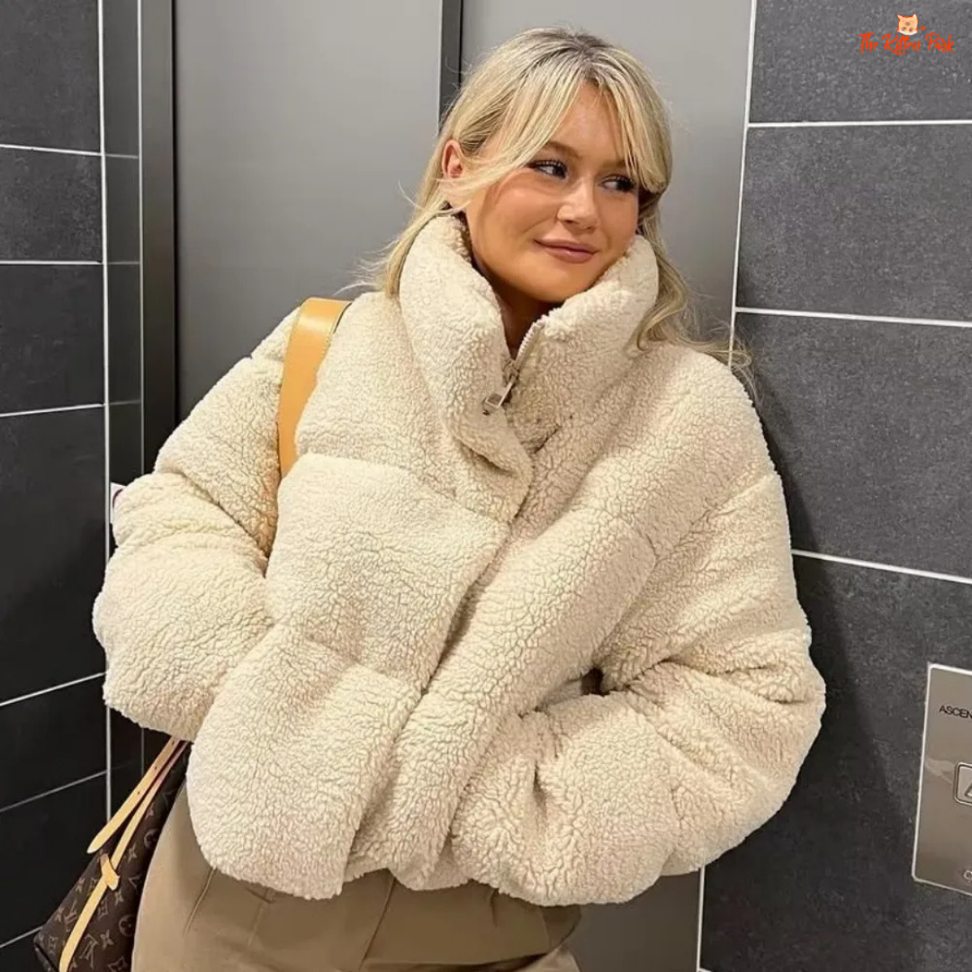 A short winter puffer coat for women with lamb wool texture, stand collar, bat sleeves, thick cotton filling, and casual zip-up style in solid color.