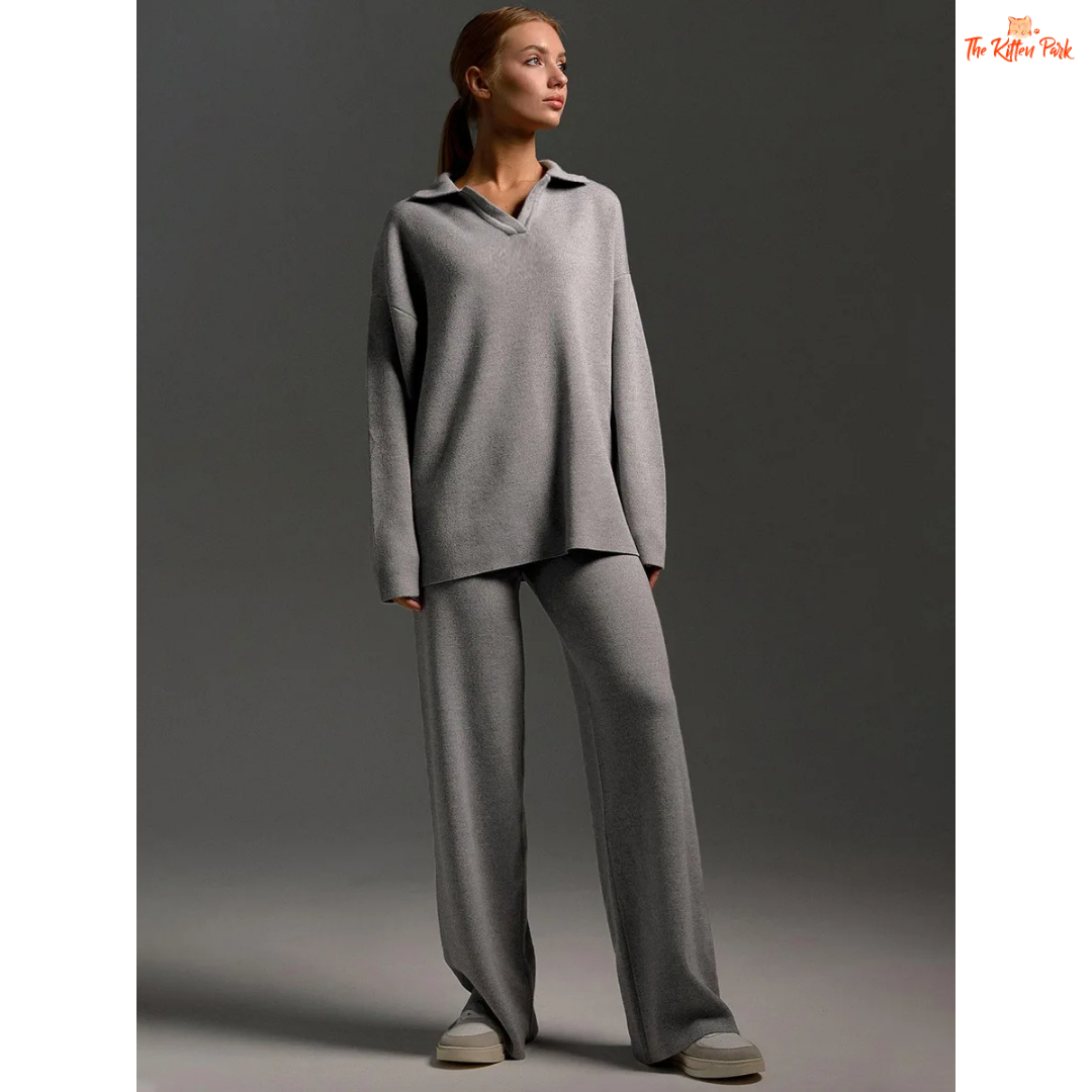 Woman wearing a gray outfit against a dark background