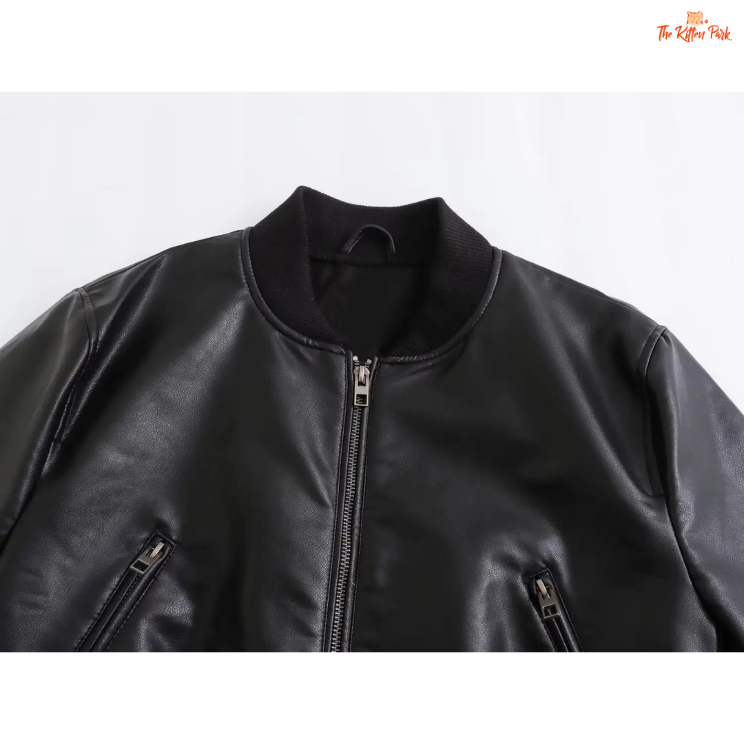 A sleek black PU leather jacket for women with a zippered front, round neck, and long sleeves, styled for modern streetwear fashion.