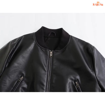 A sleek black PU leather jacket for women with a zippered front, round neck, and long sleeves, styled for modern streetwear fashion.