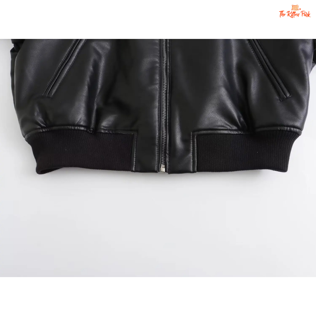 A sleek black PU leather jacket for women with a zippered front, round neck, and long sleeves, styled for modern streetwear fashion.
