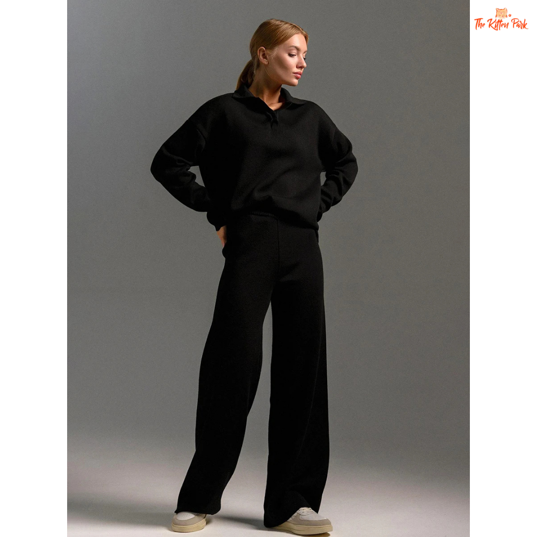 Person wearing a black outfit on a gray background