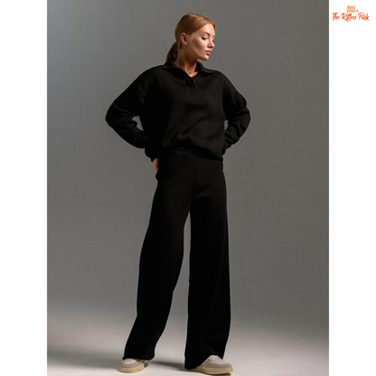 Person wearing a black outfit on a gray background