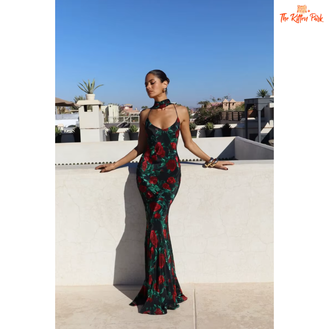 Elegant printed backless halter maxi dress with spaghetti straps, perfect for evening parties and summer events. Features a natural waistline and floor-length silhouette.